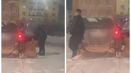 Астанада ер адам әйелін көліктен сүйреп жолға түсіріп тастаған (видео)